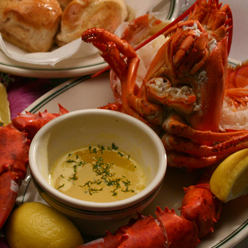 image of boiled lobster and melted butter from the seafood restaurant Poor Boy's Riverside Inn - Great Seafood